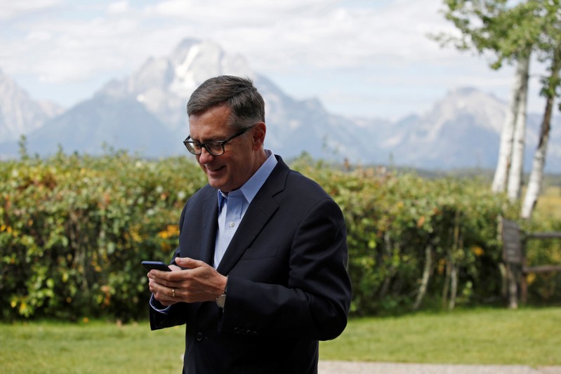 Federal Reserve Vice Chair Richard Clarida reacts as he holds his phone during the three-day