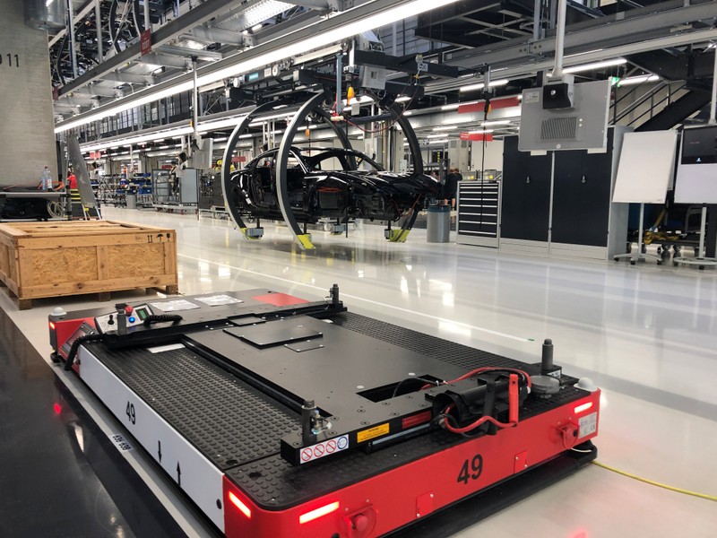 Automated vehicles carry parts for building Porsche Taycan electric cars at Porsche's