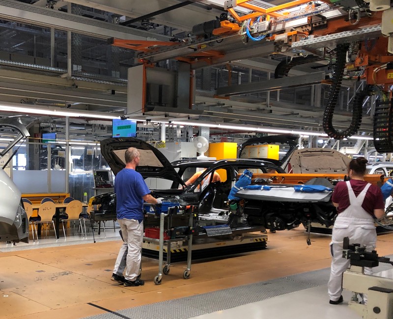 Workers install dashboards in Volkswagen ID.3 cars at the automaker's Zwickau assembly plant in