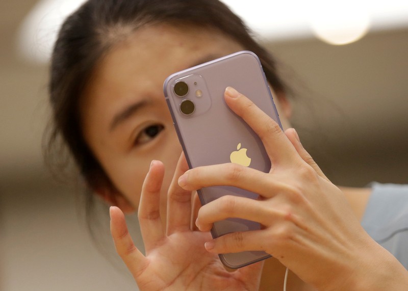 FILE PHOTO: A customer tests Apple's iPhone 11 after it went on sale at the Apple Store in