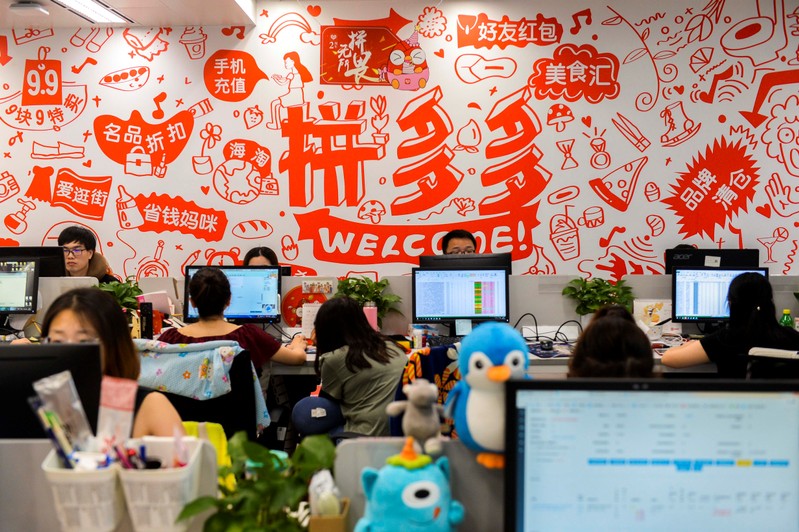 People are seen at their desks at the headquarters of Chinese online group discounter Pinduoduo