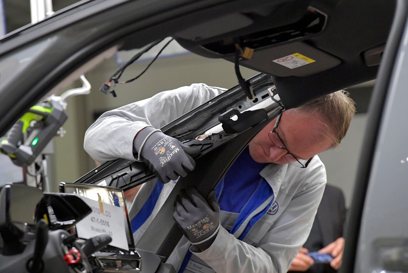 An employee works at a production line of a a new electric Volkswagen model ID.3 in Zwickau