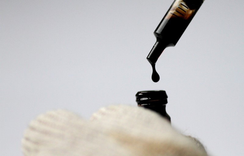 FILE PHOTO: Illustration photo of crude oil being dispensed into a bottle