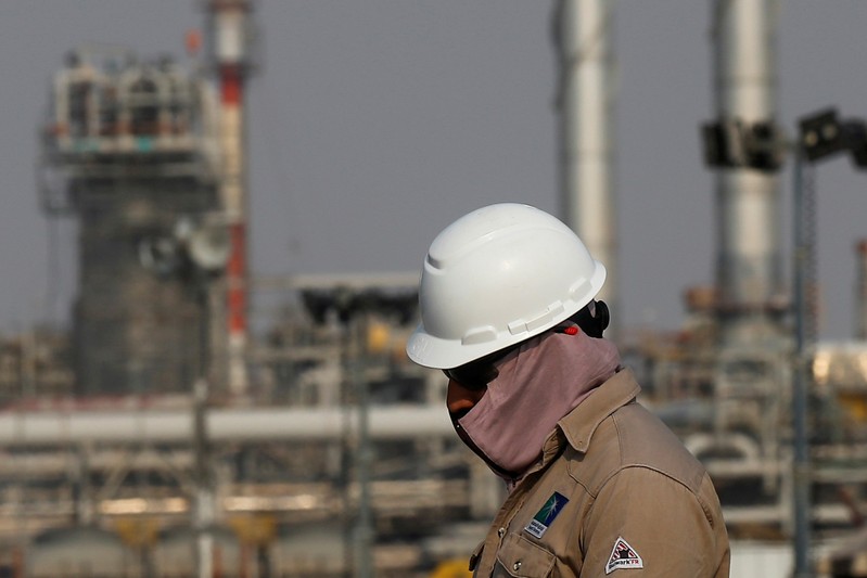 FILE PHOTO: FILE PHOTO: An employee looks on at Saudi Aramco oil facility in Abqaiq