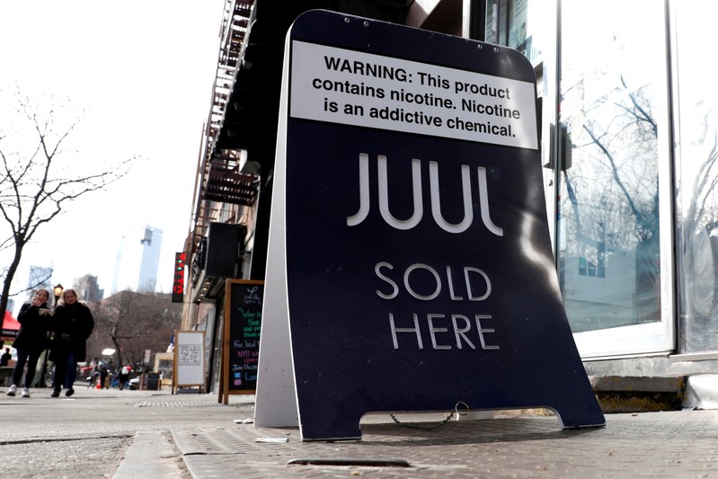 FILE PHOTO: A sign advertising Juul brand vaping products is seen outside a shop in Manhattan