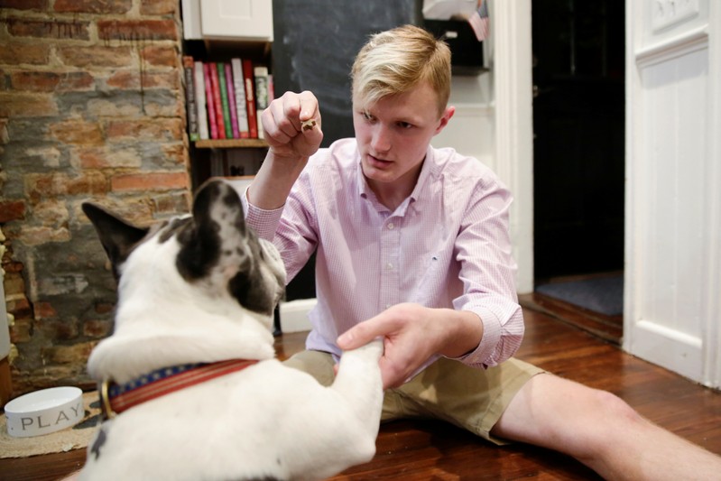 William Smith plays with his dog Hank at his home in Newburyport
