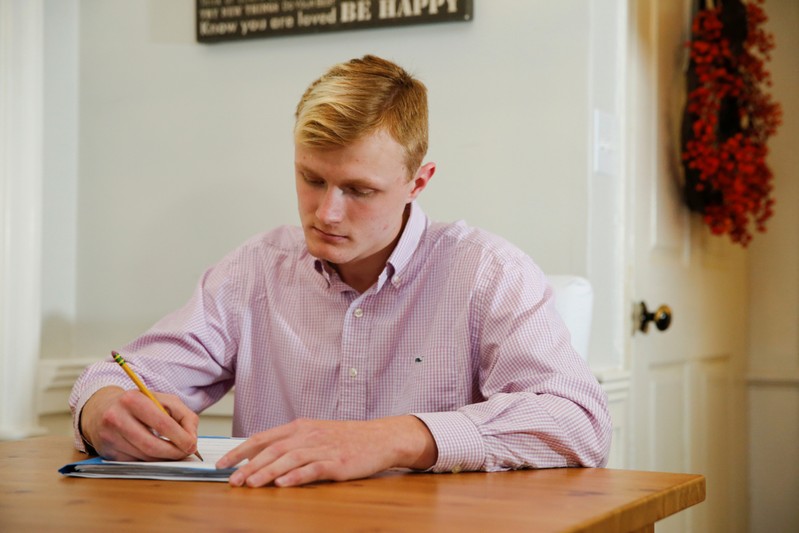 William Smith does homework at his home in Newburyport