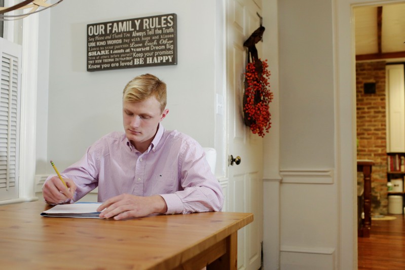 William Smith does homework at his home in Newburyport