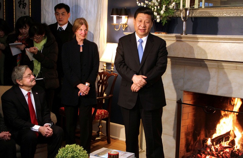 FILE PHOTO: China's Vice President Xi Jinping (R) talks with area residents in the home of