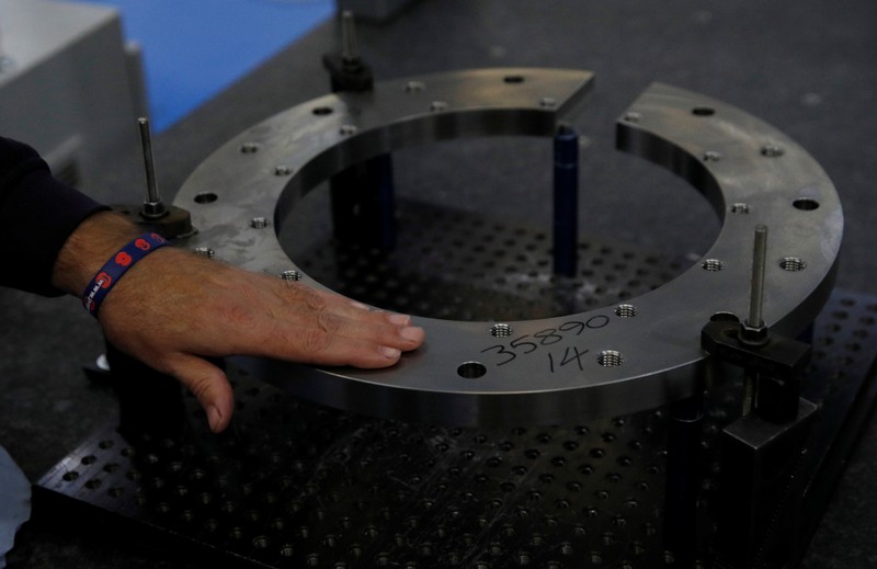Engineer examines part of an engine casing at Swiftool Precision Engineering Ltd's facility