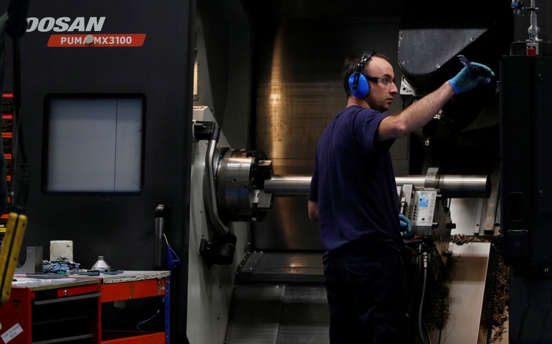 Engineer works on a precision lathe at Swiftool Precision Engineering Ltd's facility near