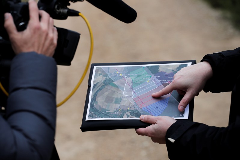 A member of the France's BEA aviation safety agency shows a map during a scour of an