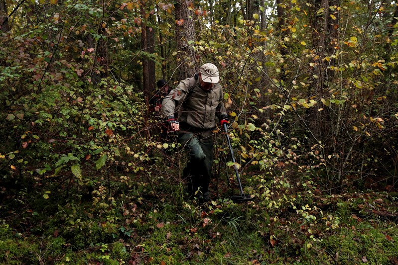 A volunteer scours an uninhabited wood at the call of the France's BEA aviation safety agency