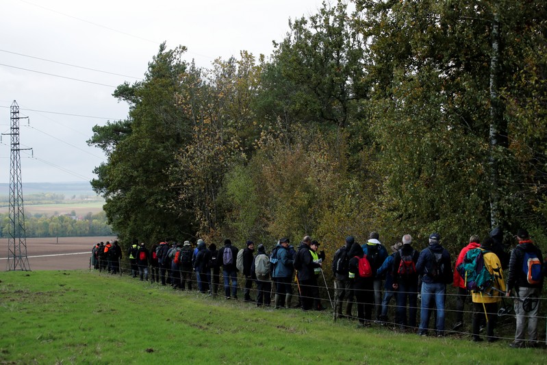 Volunteers scour an uninhabited wood at the call of the France's BEA aviation safety agency to