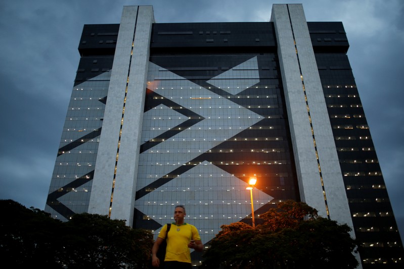 A man walks in front of Banco do Brasil headquarters building  in Brasilia