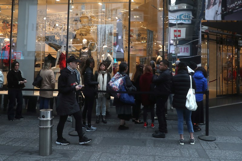 People line up to get into the H&M store for the Giambattista Valli collection in Times Square