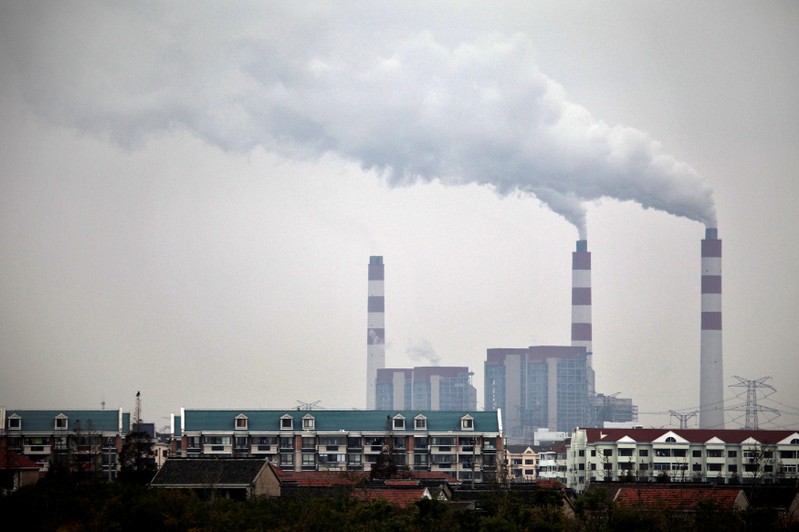 FILE PHOTO: Smokes comes out of a factory chimney in a mixed residential and industrial area of