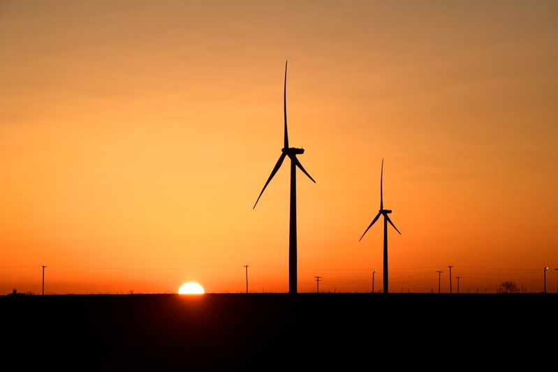 FILE PHOTO: Wind turbines operate at sunrise in the Permian Basin oil and natural gas