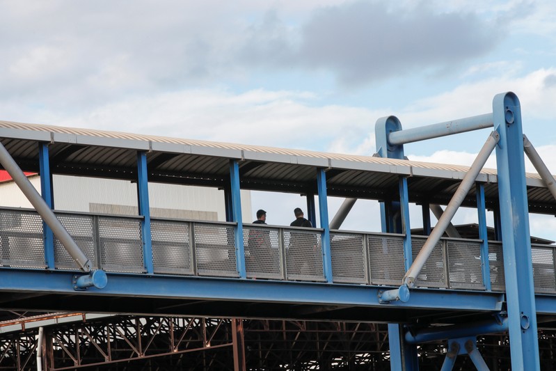 Ilva steel plant workers are seen outside the plant during a 24-hour strike against