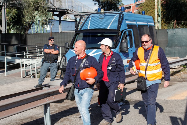 Ilva steel plant workers are seen outside the plant during a 24-hour strike against