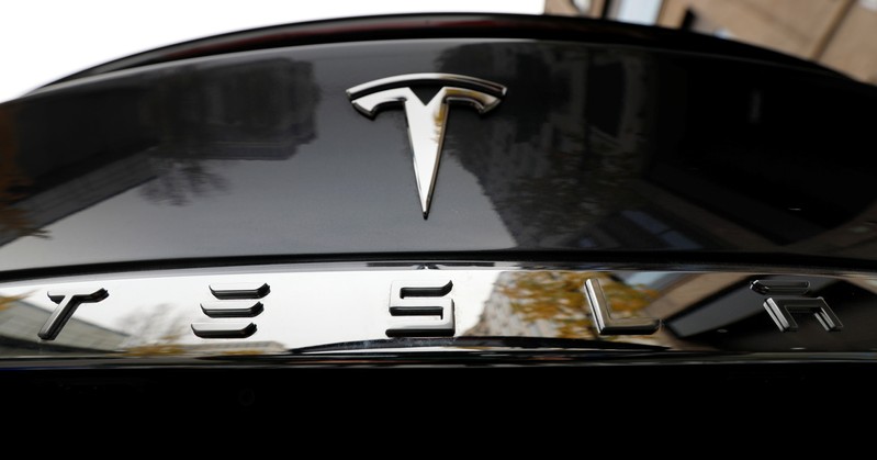 The company logo is pictured on a Tesla Model X electric car in Berlin