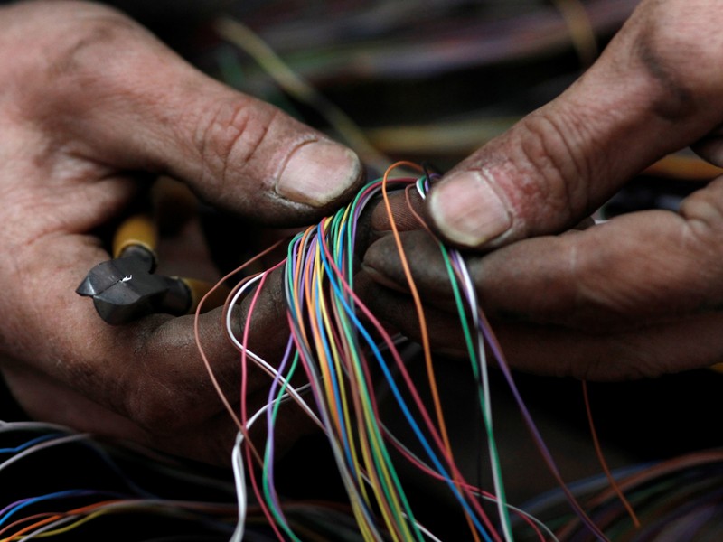 FILE PHOTO: A British Telecom engineer repairs cables to the telephone and internet network in