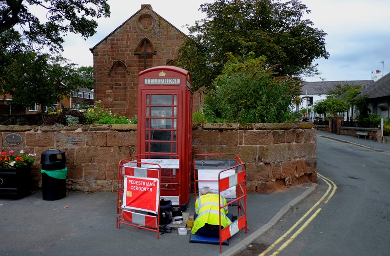 FILE PHOTO: A BT telephone engineer carries out work outside a traditional British Telecom red