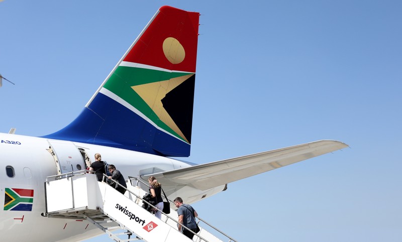 FILE PHOTO: Passengers board a South African Airways plane at the Port Elizabeth International