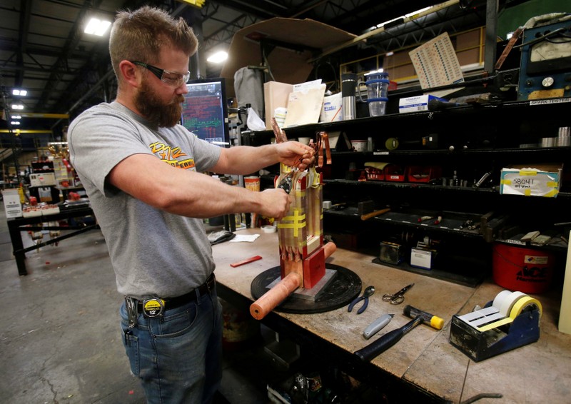 FILE PHOTO: Sub-assembly worker Joel Dykema works on the sub-assembly of a transformer in the