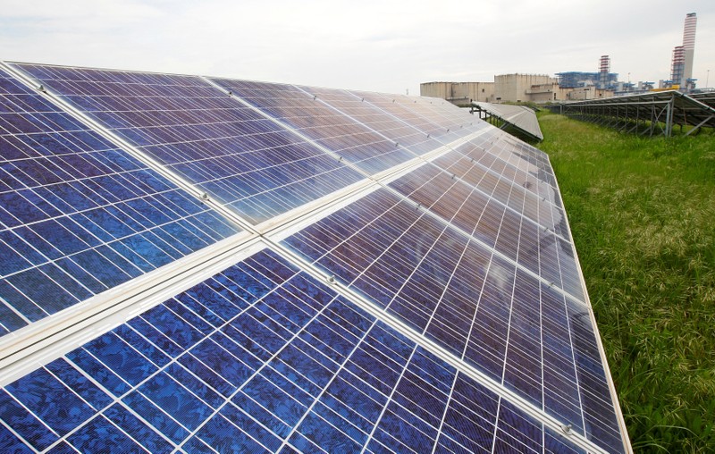 FILE PHOTO: Solar panels near the skeletons of an abandoned nuclear site at Enel's power plant