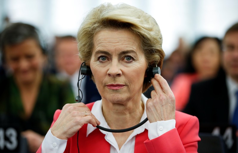 European Commission President-elect von der Leyen adjusts her earphones at the European