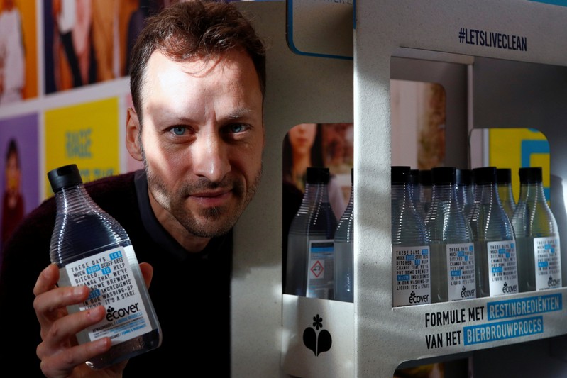 Ecover's Innovation Manager Domen poses with a bottle of dishwasher soap at the factory in