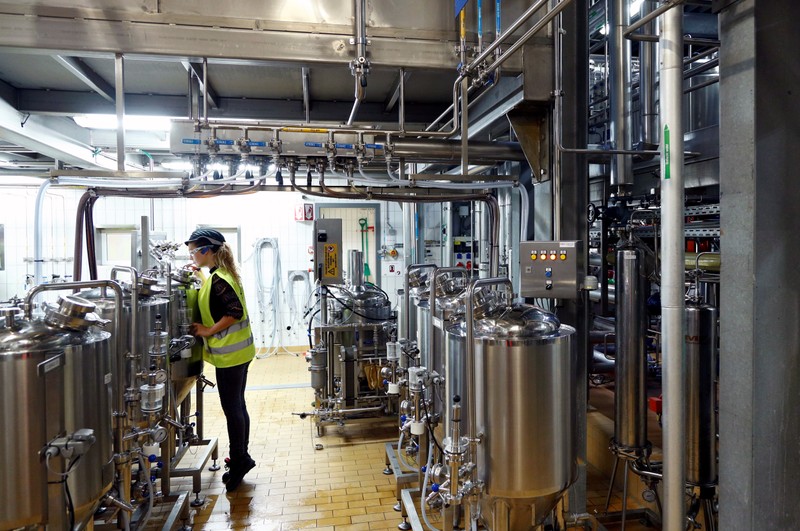 A worker checks beer quality at Anheuser-Busch InBev brewery in Leuven