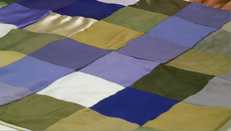 Patchwork of different types of material dyed using bacteria in a lab at biotech firm Colorifix