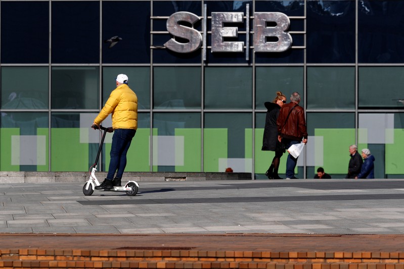 FILE PHOTO: People walk past SEB bank sign in Vilnius