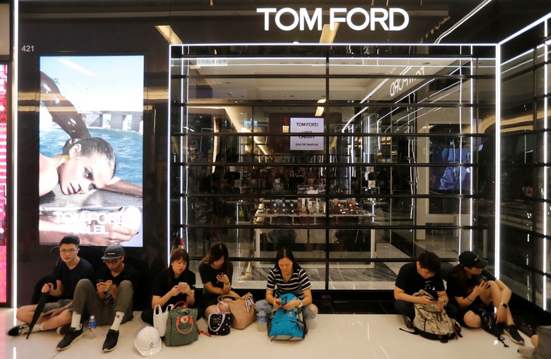 FILE PHOTO: Demonstrators sit outside a close shop as they attend a rally to support the