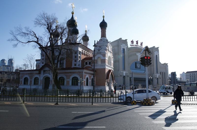 A man runs near an Orthodox church on a cold winter day in Harbin