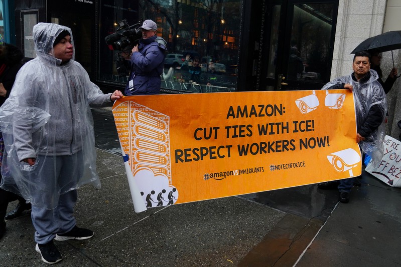 People take part in a rally against Amazon and their business practices in the Manhattan