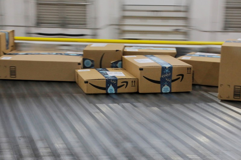 Amazon packages are transported by conveyor belts inside of an Amazon fulfillment center on