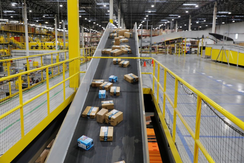 Amazon packages are transported by conveyor belts inside of an Amazon fulfillment center on