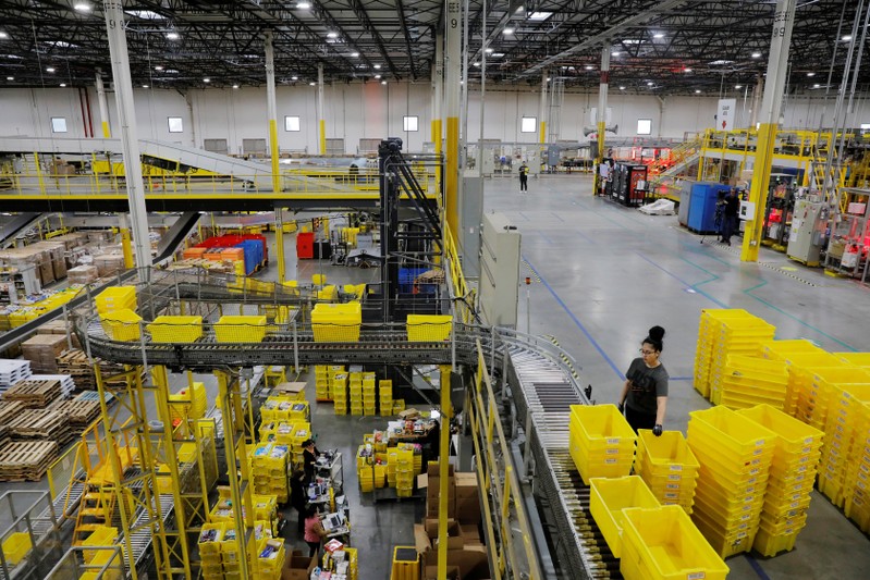 Amazon workers perform their jobs inside of an Amazon fulfillment center on Cyber Monday in