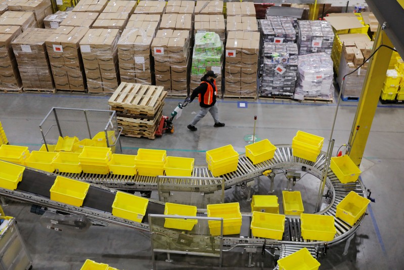 Amazon workers perform their jobs inside of an Amazon fulfillment center on Cyber Monday in