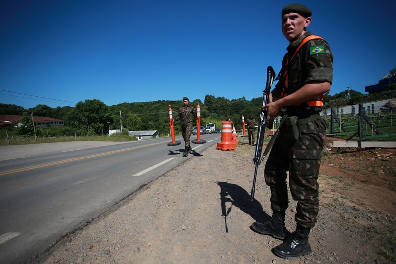 Soldiers of the Brazilian army patrol near the Spa de Vinho hotel, which will host the next