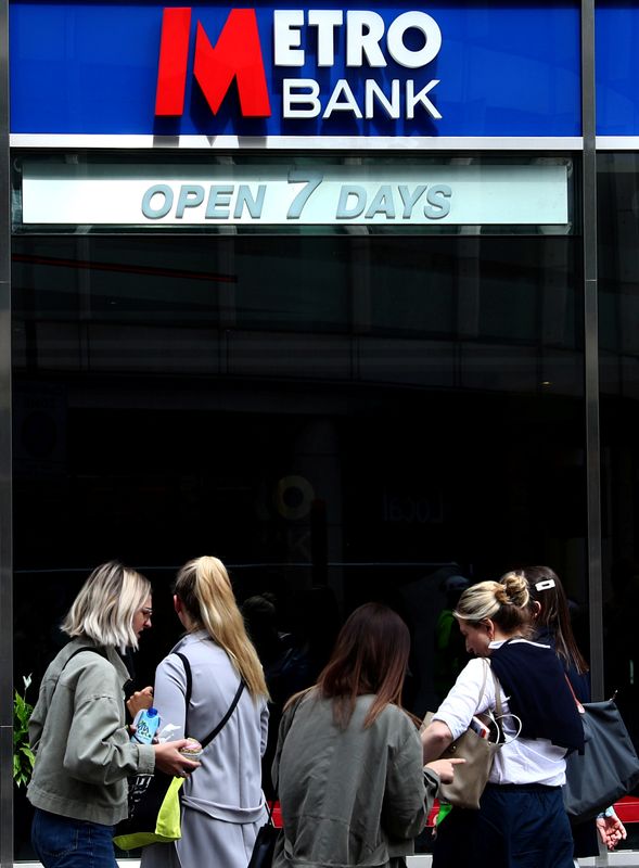 FILE PHOTO: People walk past a Metro Bank in London