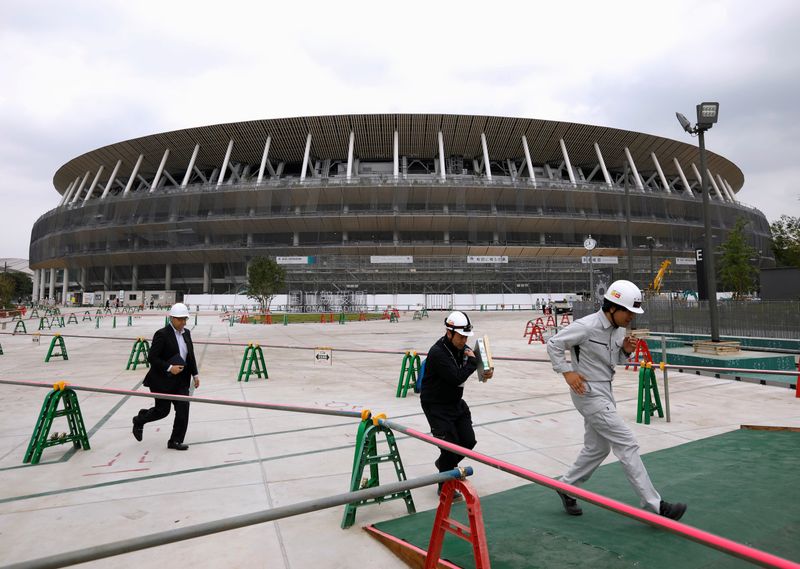 FILE PHOTO: Workers are seen at the construction site of the New National Stadium, the main