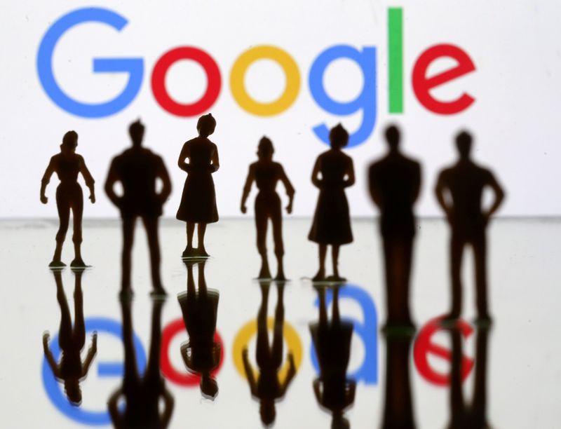 FILE PHOTO: Small toy figures are seen in front of Google logo in this illustration picture