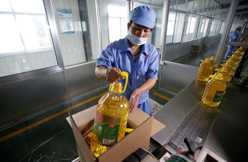 FILE PHOTO: A worker packs bottles of soybean oil made from imported U.S. soybeans at the plant