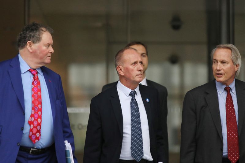 British cave diver Vernon Unsworth emerges from court with attorneys after a U.S. District