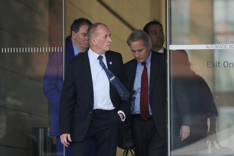 British cave diver Vernon Unsworth emerges from court with attorneys after a U.S. District