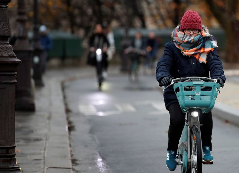 Person rides bicycle during rush hour as a strike by all unions of the Paris transport network